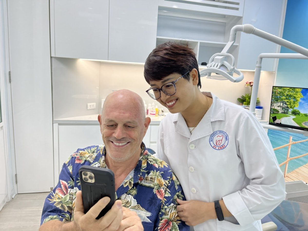 International patient smiling with dentist after treatment at Australian Dental Clinic