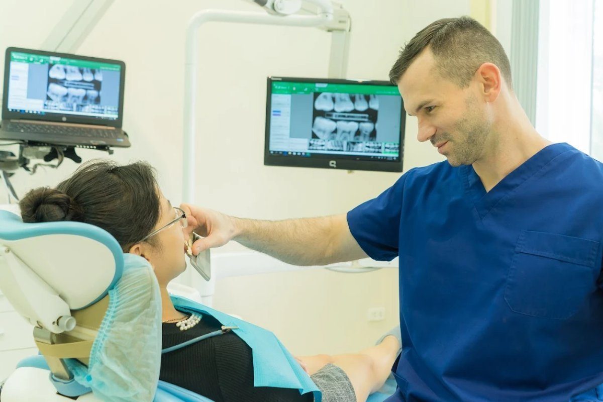 Dentist consulting patient with digital X-rays at Westcoast International Dental